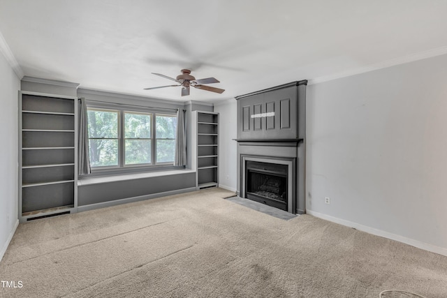 unfurnished living room with ceiling fan, carpet, baseboards, a fireplace with flush hearth, and ornamental molding