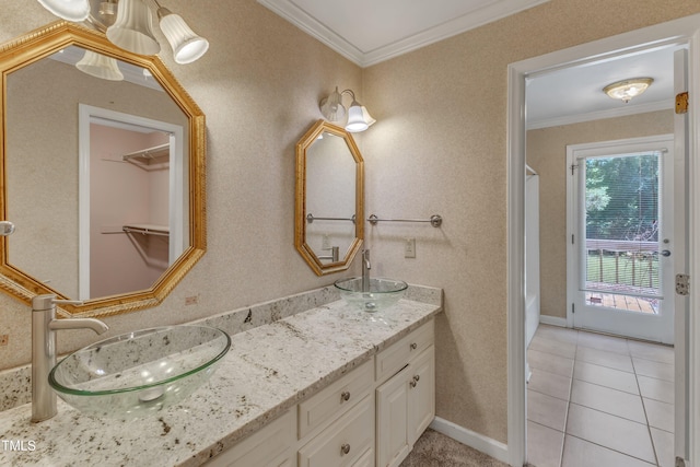 full bathroom featuring a sink, tile patterned flooring, crown molding, and double vanity
