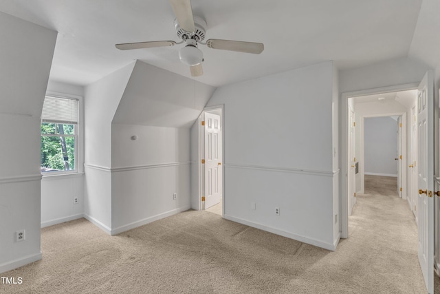 additional living space featuring carpet floors, baseboards, and lofted ceiling