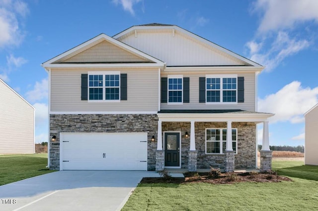 craftsman inspired home with a garage, a front yard, and a porch