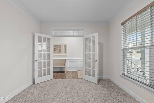 spare room featuring ornamental molding, french doors, carpet floors, and baseboards