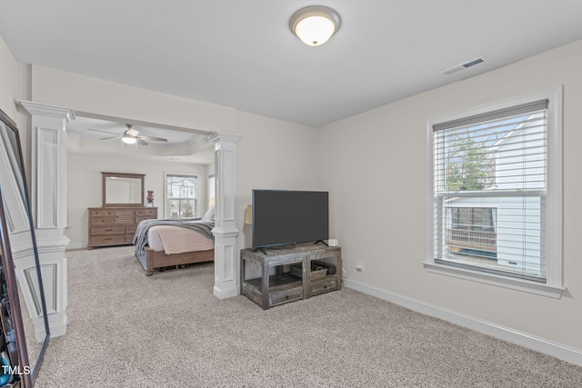 bedroom featuring light carpet, baseboards, visible vents, a ceiling fan, and ornate columns