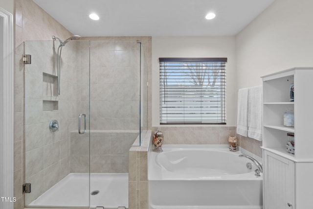 full bath with recessed lighting, a garden tub, and a shower stall