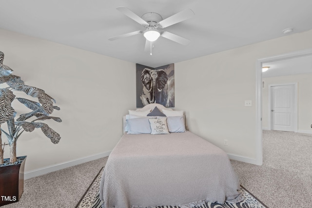 carpeted bedroom featuring baseboards and a ceiling fan