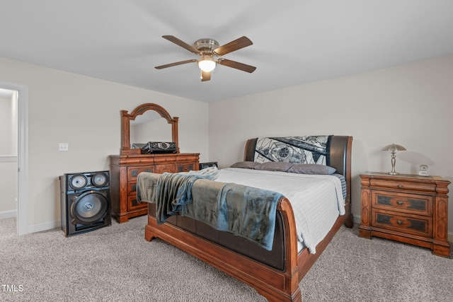 bedroom with light carpet, a ceiling fan, and baseboards