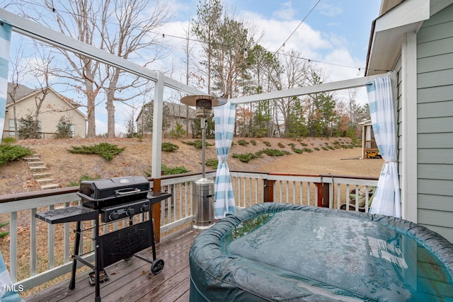 wooden deck with a grill