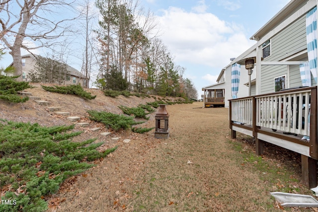 view of yard with a fireplace and a wooden deck