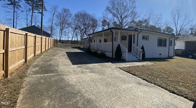 view of side of property featuring covered porch