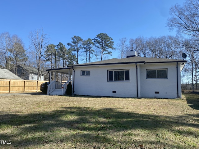 back of house featuring a yard