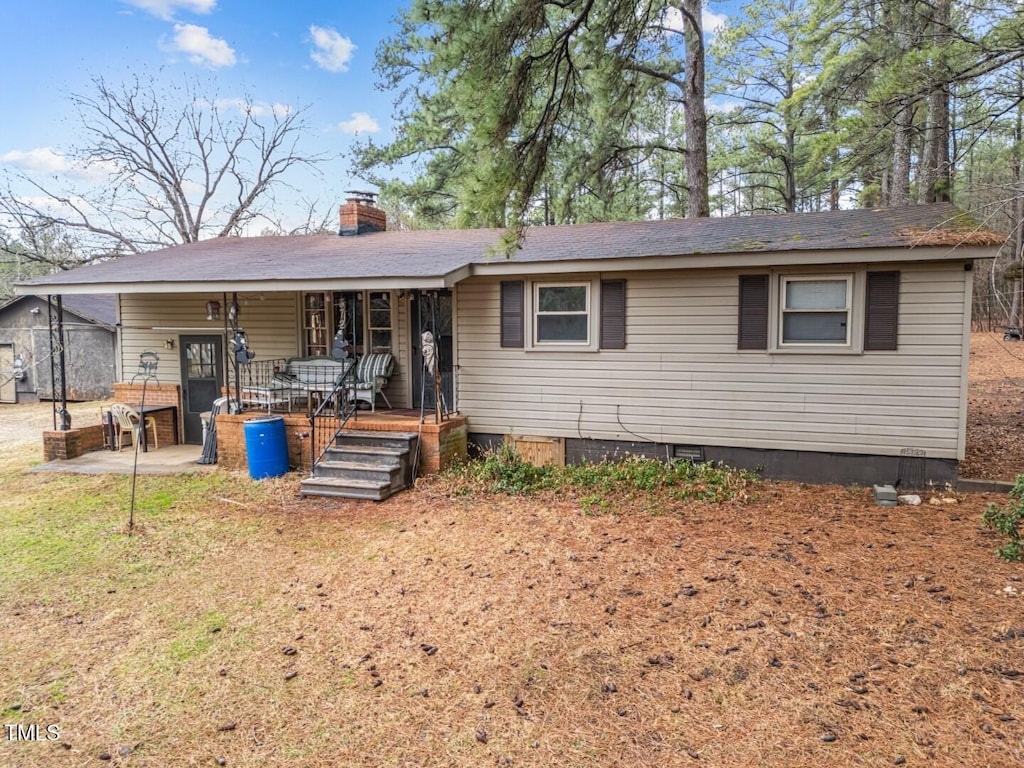 rear view of house featuring a patio and covered porch