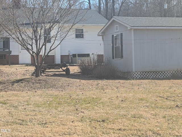 view of side of home with a lawn