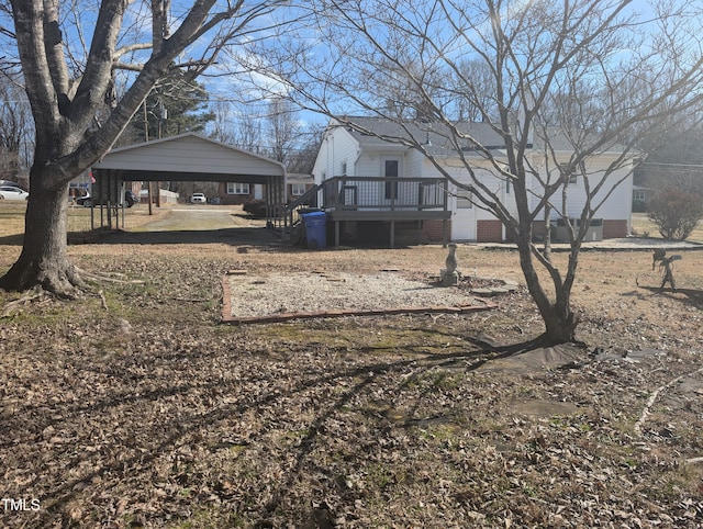 view of yard with a wooden deck and a carport