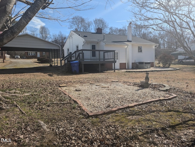 back of property featuring a wooden deck, central AC unit, and a carport