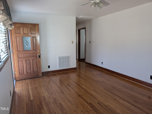 interior space featuring dark wood-type flooring and ceiling fan