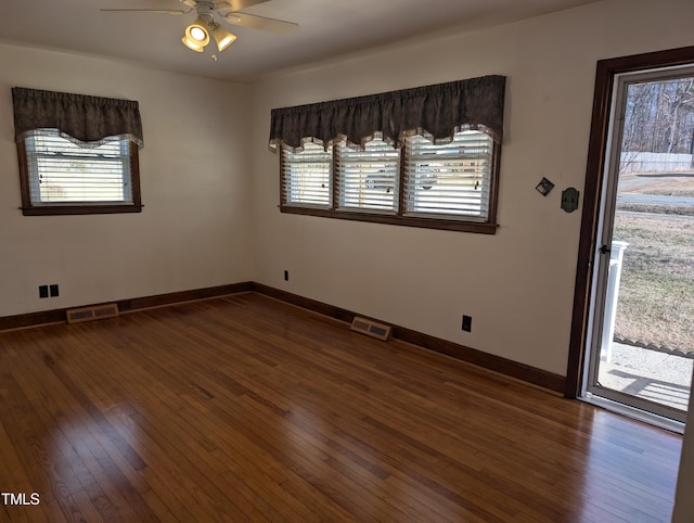 unfurnished room with ceiling fan and dark hardwood / wood-style flooring