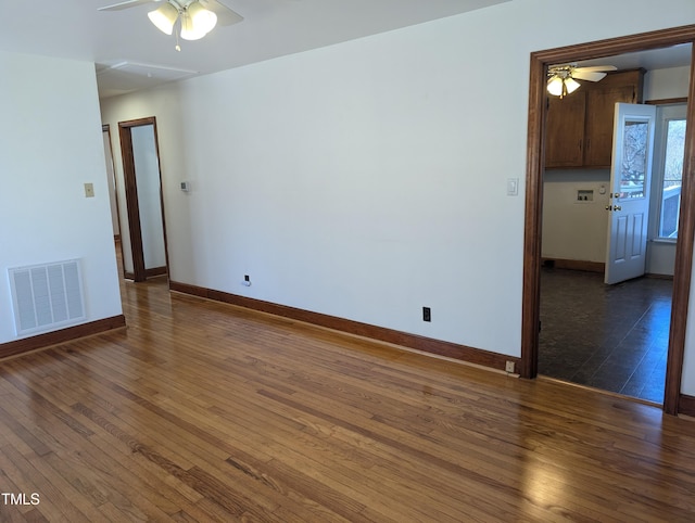 unfurnished room with dark hardwood / wood-style flooring and ceiling fan