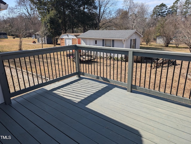 wooden deck with a yard and a storage shed