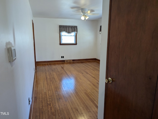 empty room with wood-type flooring and ceiling fan