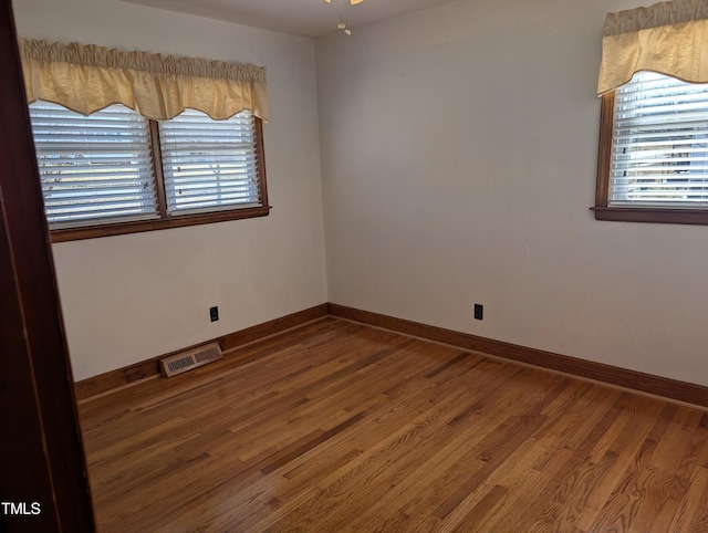 spare room featuring wood-type flooring