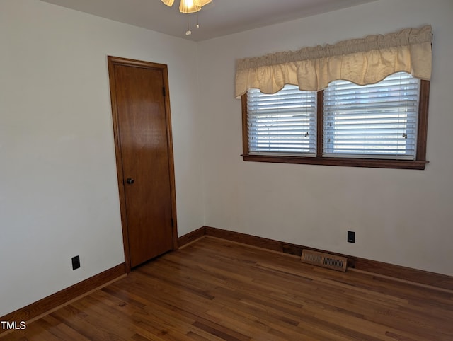 spare room featuring dark hardwood / wood-style floors