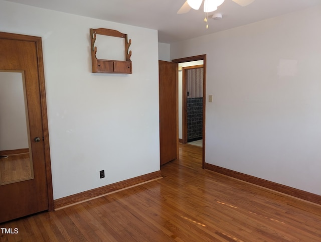 spare room featuring hardwood / wood-style floors and ceiling fan