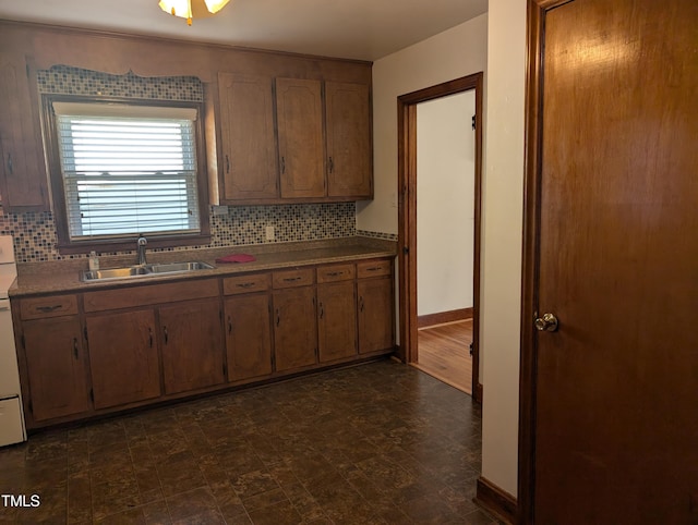 kitchen featuring tasteful backsplash, sink, and stove