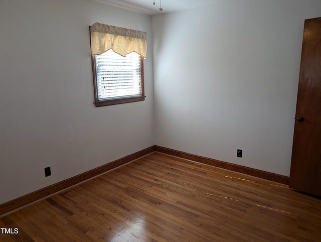 unfurnished room with dark wood-type flooring