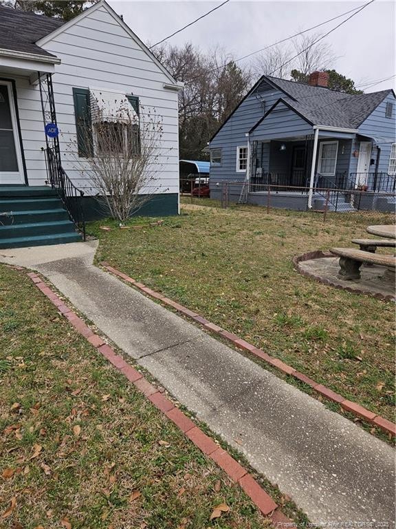 view of side of home with a lawn