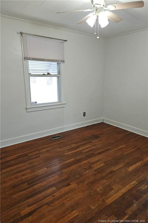 spare room featuring ceiling fan and dark hardwood / wood-style floors