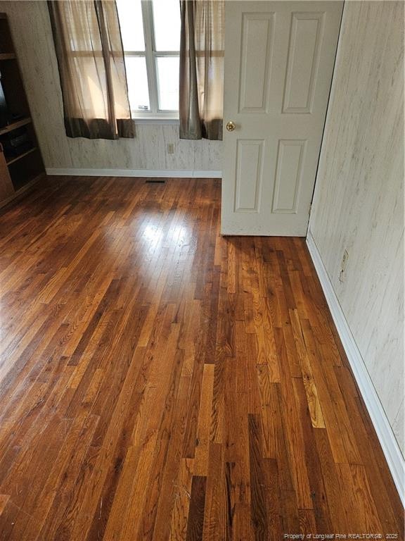 spare room featuring dark hardwood / wood-style floors