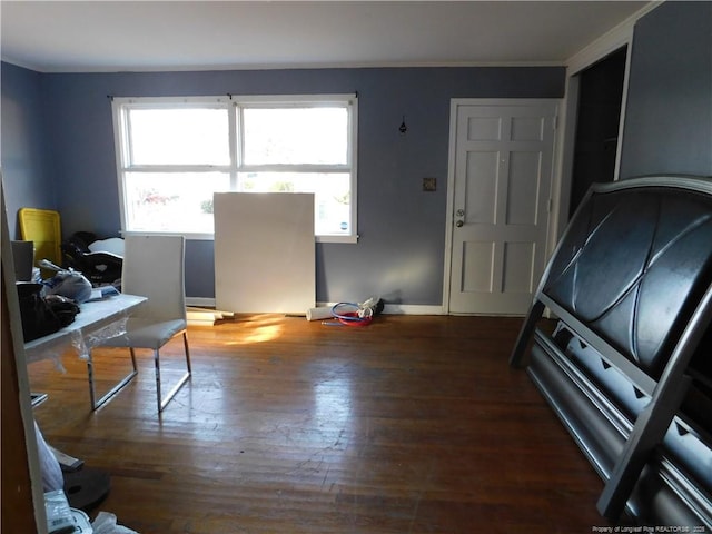 interior space featuring crown molding and dark wood-type flooring