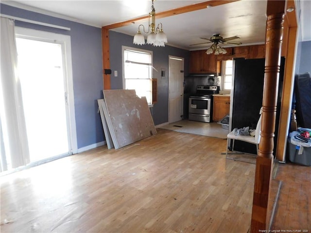 kitchen with pendant lighting, ceiling fan with notable chandelier, light wood-type flooring, and electric range