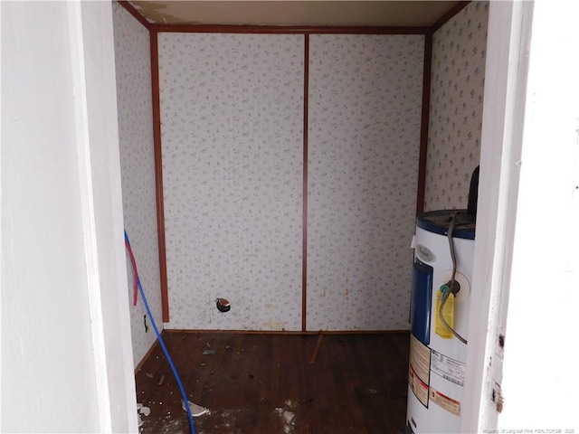 interior space with wood-type flooring and water heater