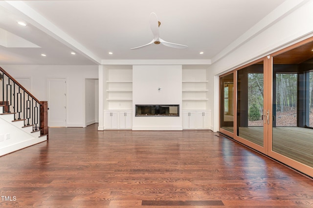 unfurnished living room with dark hardwood / wood-style flooring, ceiling fan, and built in features