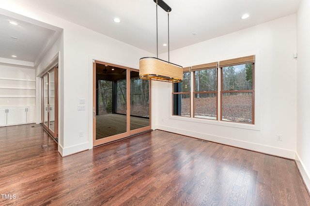 unfurnished dining area featuring dark hardwood / wood-style flooring