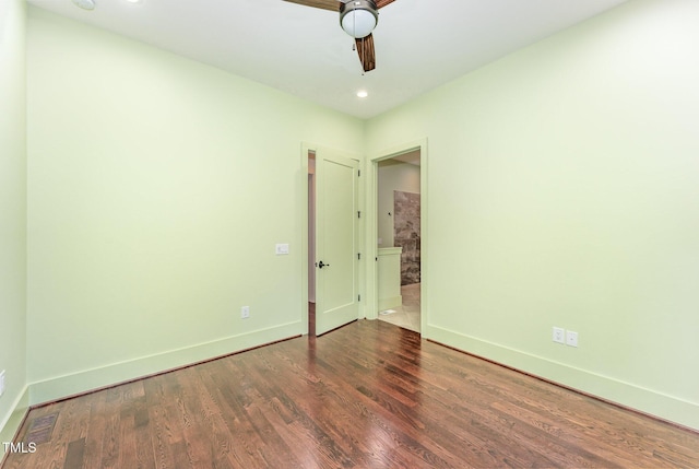 unfurnished bedroom featuring ceiling fan and dark hardwood / wood-style flooring