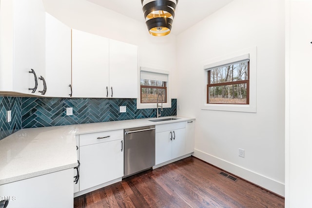 kitchen featuring sink, white cabinetry, dishwasher, dark wood-type flooring, and tasteful backsplash