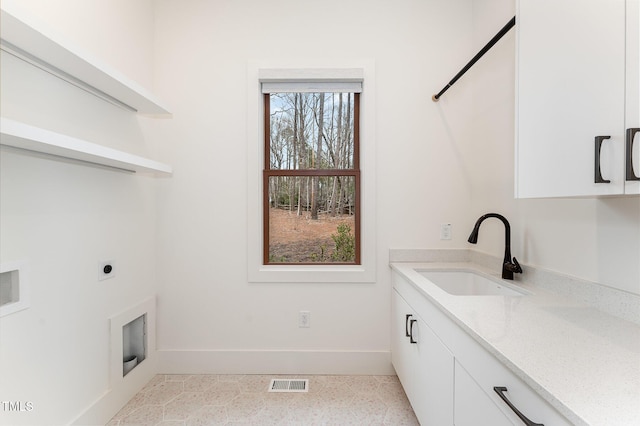 laundry room with sink, cabinets, and hookup for an electric dryer