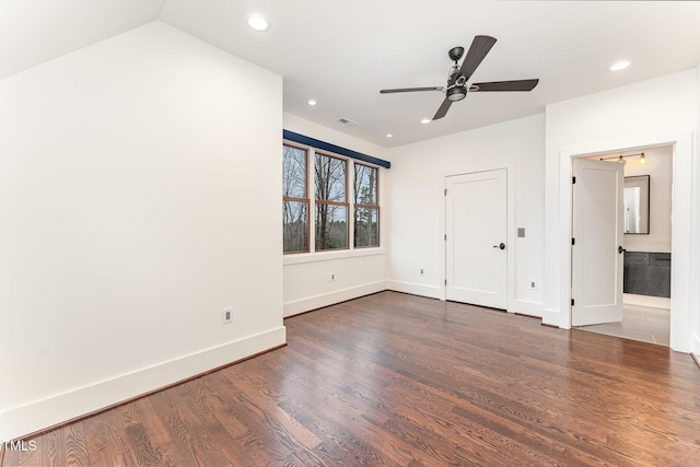 unfurnished bedroom with connected bathroom, ceiling fan, and dark wood-type flooring