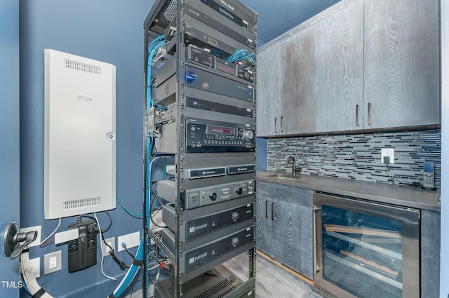 utility room featuring sink and wine cooler