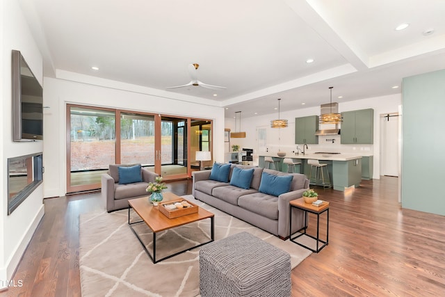 living room with light hardwood / wood-style flooring and ceiling fan