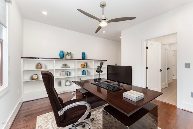 office area with ceiling fan and dark hardwood / wood-style floors