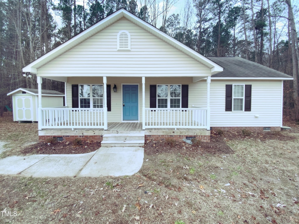 610 Lockwood Dr, Clayton, NC 27527 - view of front of home with a porch and a storage shed
