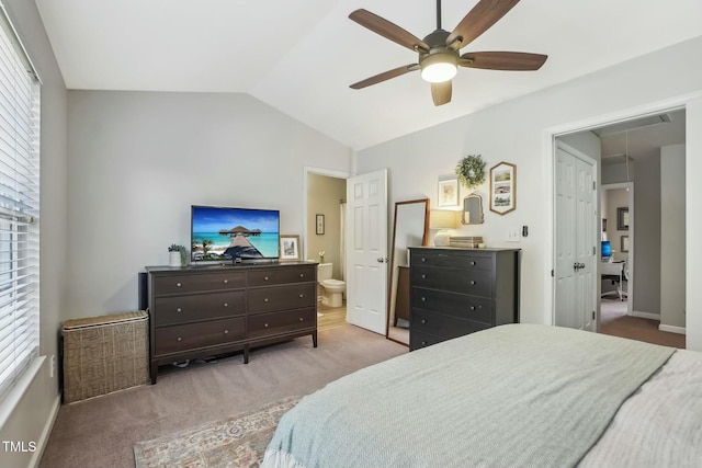 carpeted bedroom with vaulted ceiling, ensuite bathroom, and ceiling fan