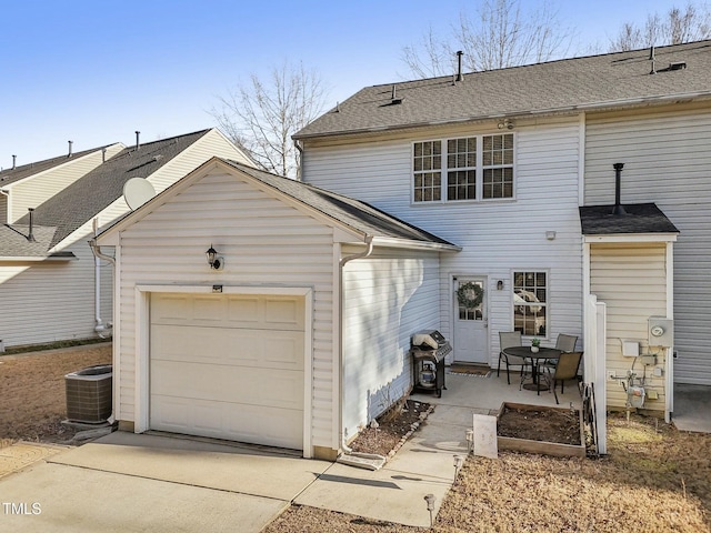 rear view of property featuring central AC and a patio area