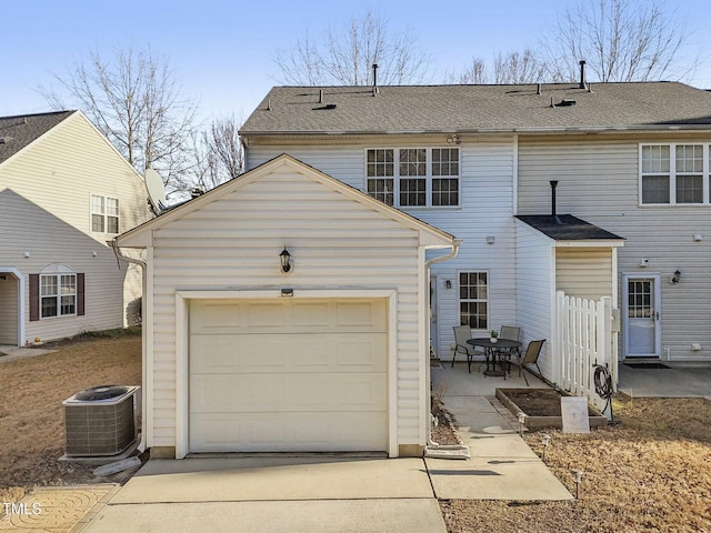 view of front of home featuring a garage and central AC unit