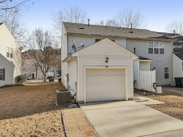 exterior space featuring a garage and central air condition unit