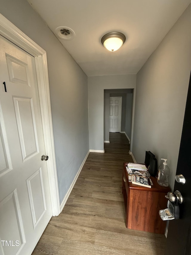 hall with wood-type flooring