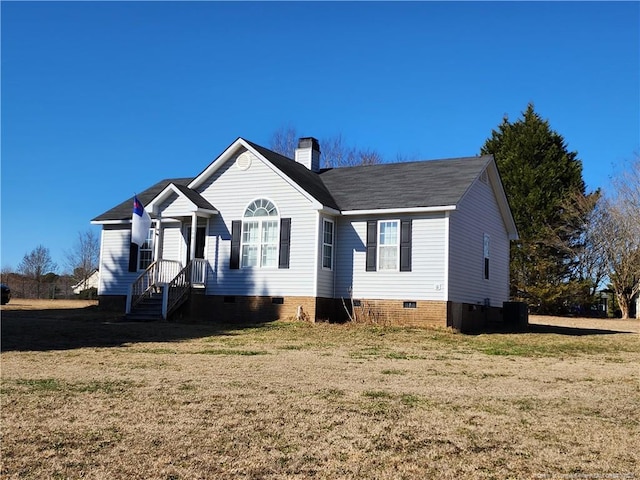 view of front of property featuring cooling unit and a front lawn