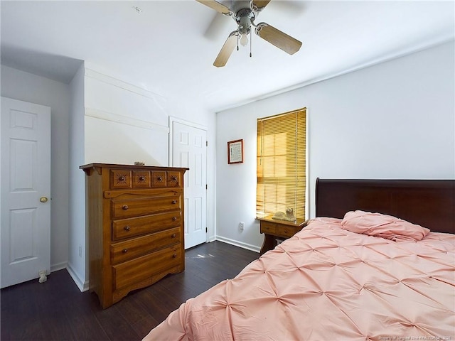 bedroom with dark hardwood / wood-style flooring and ceiling fan